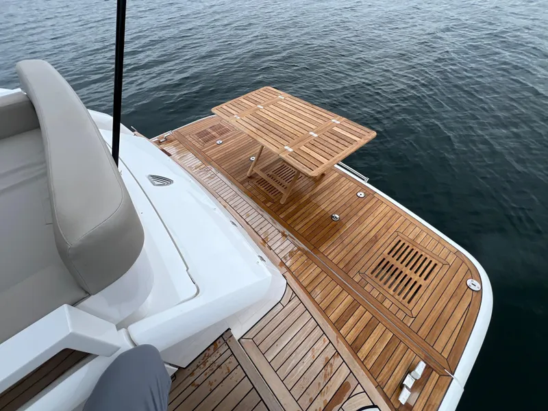Slide: The Image of Teak deck of 2024 Fairline Squadron 50 yacht with wooden table. - 32