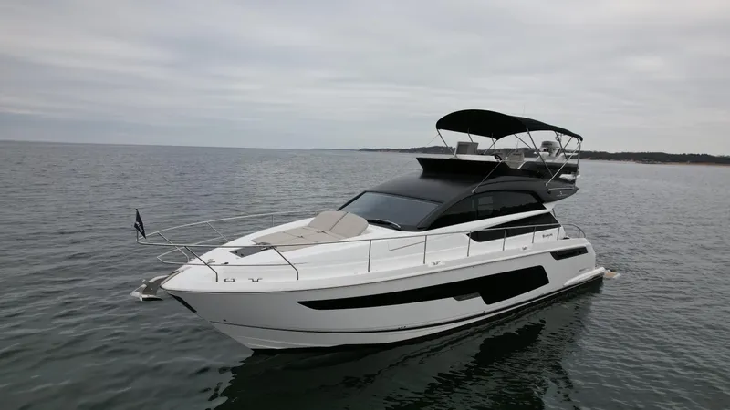 Slide: The Image of 2024 Fairline Squadron 50 luxury yacht on open water. - 34