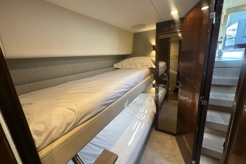Slide: The Image of 2024 Fairline Squadron 50 yacht interior with cozy bunk beds and elegant wood finishes. - 38