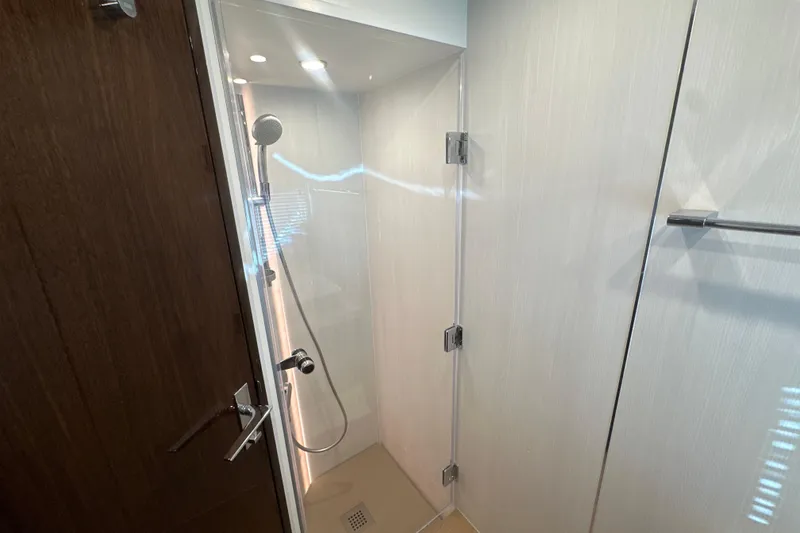 Slide: The Image of Modern shower in 2024 Fairline Squadron 50 yacht, featuring sleek design and chrome fixtures. - 49