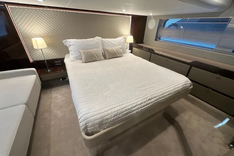 Slide: The Image of Luxurious bedroom interior of 2024 Fairline Squadron 50 yacht with elegant bedding and ambient lighting. - 51