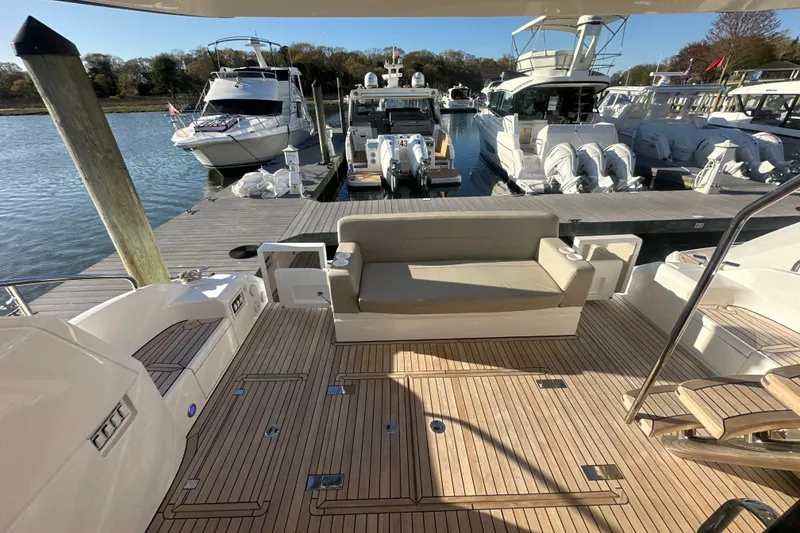 Slide: The Image of Luxury 2024 Fairline Squadron 50 yacht docked, showcasing elegant deck seating and modern design. - 57