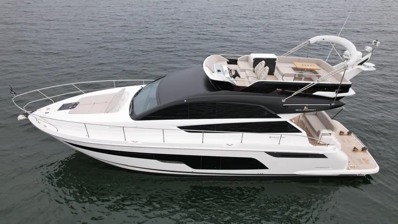 Slide: The Image of 2024 Fairline Squadron 50 luxury yacht on calm water. - 6