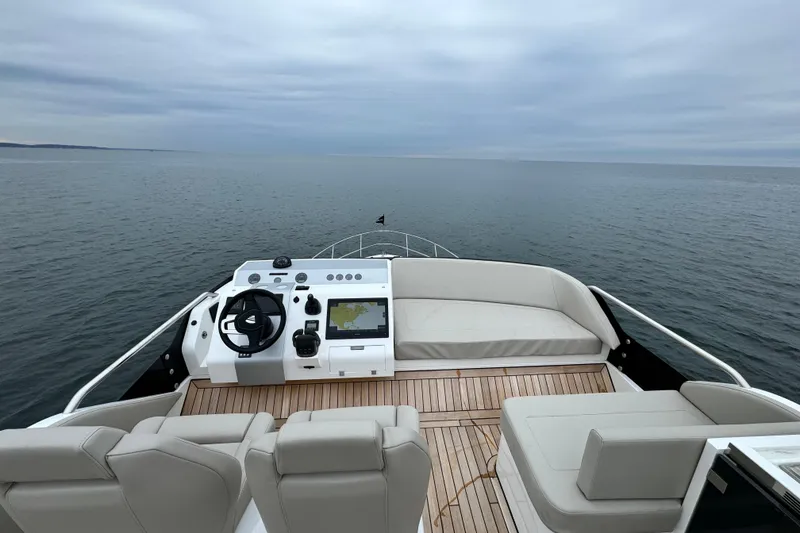 Slide: The Image of 2024 Fairline Squadron 50 yacht helm with ocean view, featuring modern navigation equipment. - 61