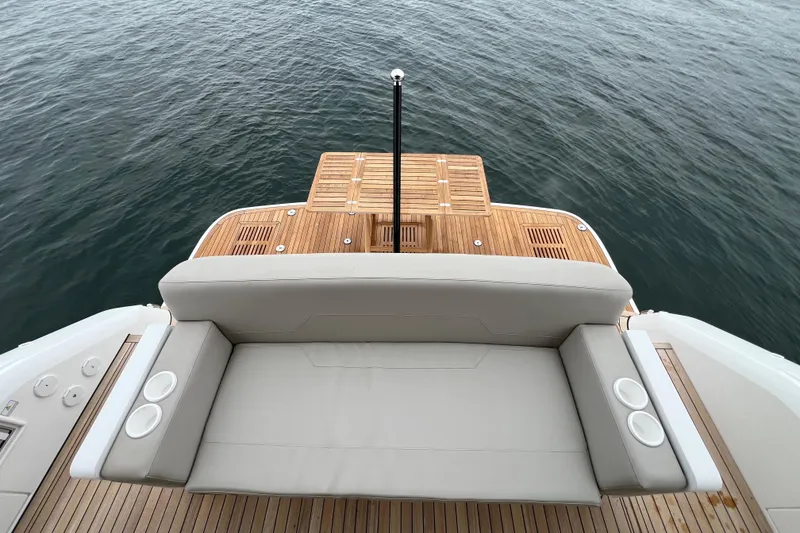 Slide: The Image of Luxury seating on 2024 Fairline Squadron 50 yacht with teak deck overlooking water. - 66