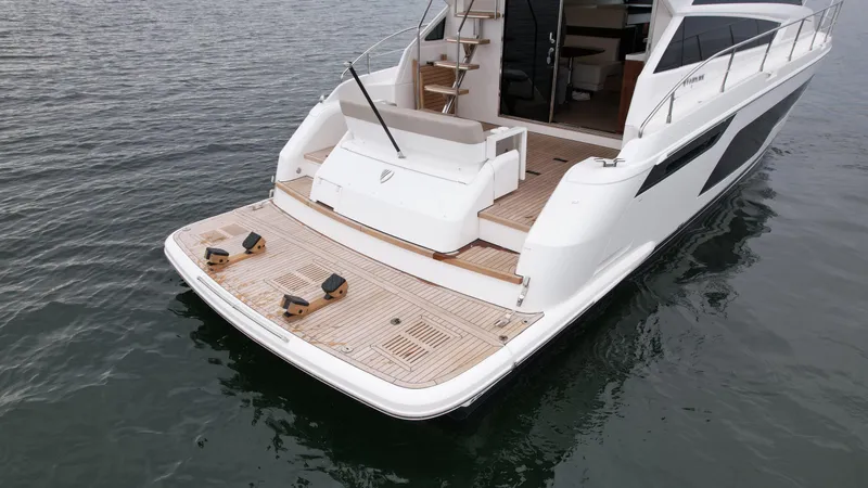 Slide: The Image of 2024 Fairline Squadron 50 yacht rear view with teak deck. - 7