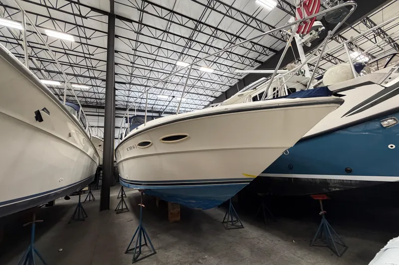 The Image of 1986 Sea Ray 340 Sundancer yacht in indoor storage, elevated on stands. - 0