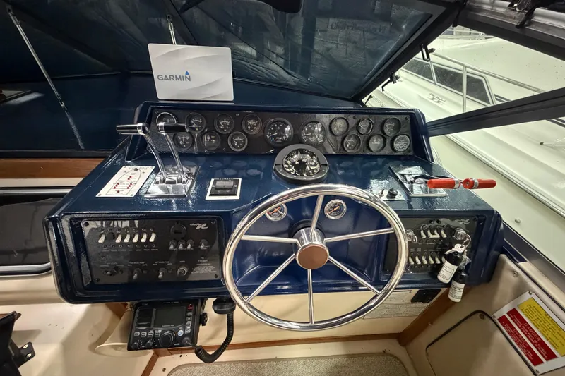 Slide: The Image of 1986 Sea Ray 340 Sundancer helm with Garmin navigation, featuring classic gauges and controls. - 11