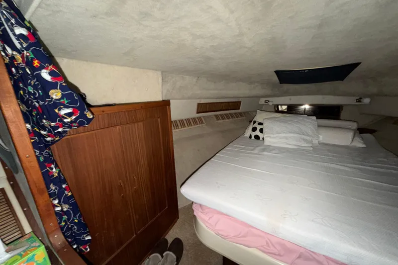 Slide: The Image of Interior cabin of 1986 Sea Ray 340 Sundancer with bed and wooden cabinet. - 22