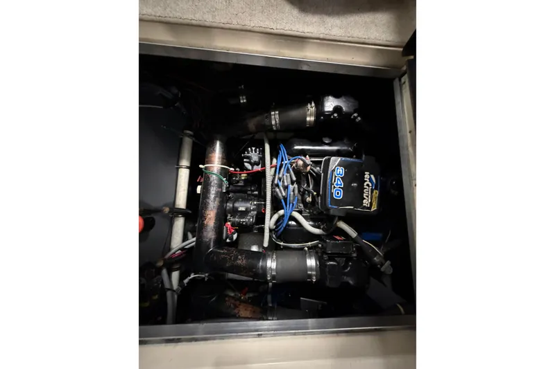 Slide: The Image of Engine compartment of a 1986 Sea Ray 340 Sundancer boat, showcasing mechanical components. - 24