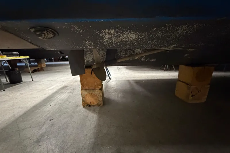 Slide: The Image of 1986 Sea Ray 340 Sundancer hull on blocks, showing propeller and underside details. - 27