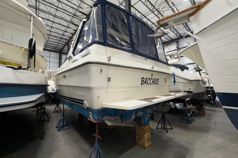 Slide: The Image of 1986 Sea Ray 340 Sundancer boat named Bacchus in indoor storage. - 8