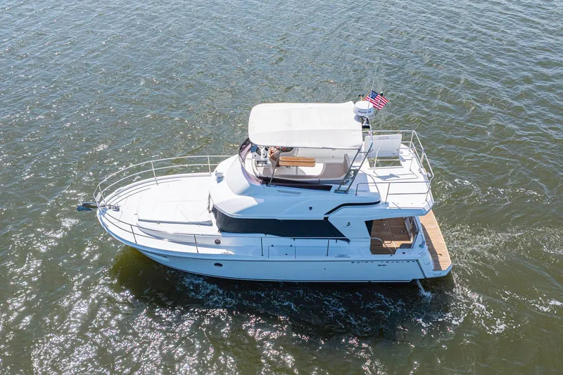 The Image of 2019 Beneteau Swift Trawler 35 cruising on open water, aerial view. - 1
