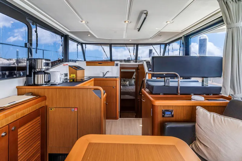 Slide: The Image of Interior of 2019 Beneteau Swift Trawler 35, featuring modern kitchen and seating area. - 16