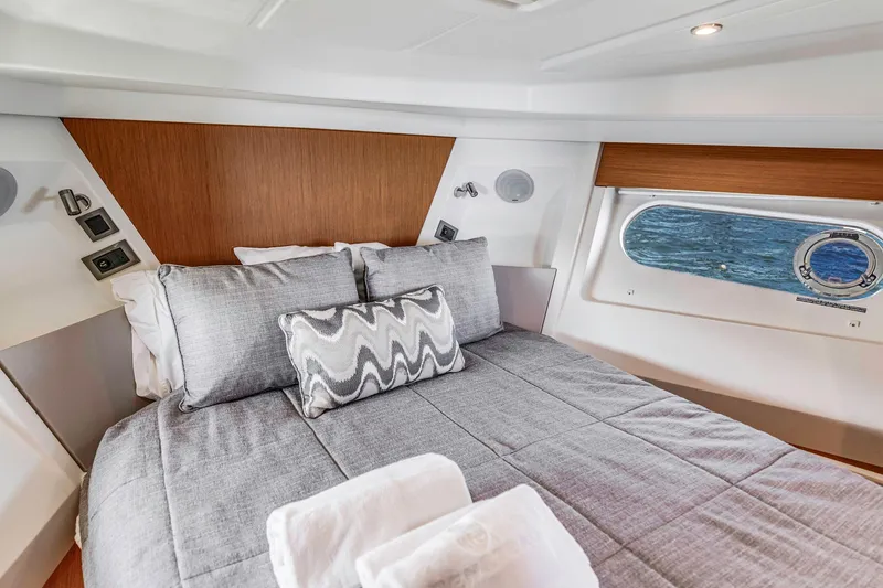 Slide: The Image of Luxurious cabin interior of 2019 Beneteau Swift Trawler 35 with elegant bedding and ocean view. - 24
