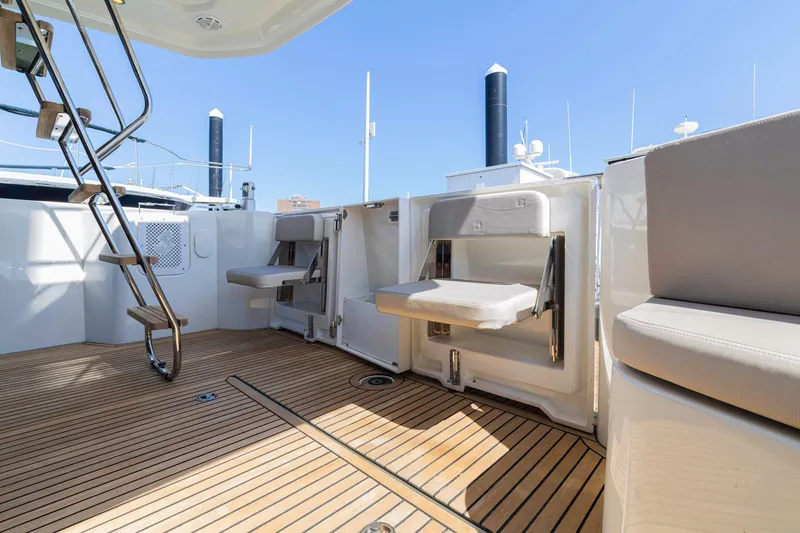 Slide: The Image of 2019 Beneteau Swift Trawler 35 deck with seating and ladder, showcasing modern design. - 31