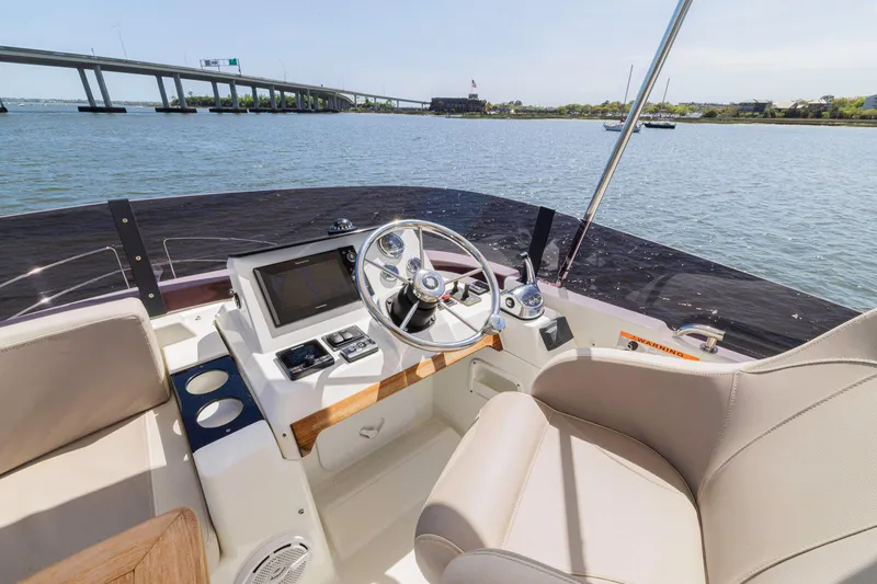 Slide: The Image of 2019 Beneteau Swift Trawler 35 helm with scenic waterway view. - 36
