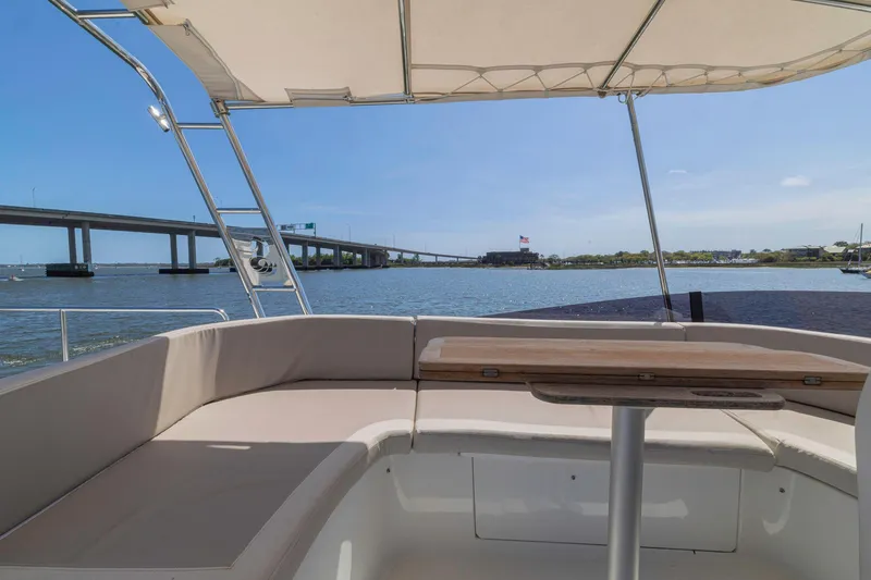 Slide: The Image of 2019 Beneteau Swift Trawler 35 deck view with bridge and waterway backdrop. - 37