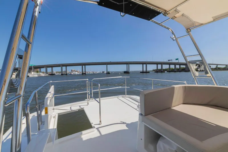 Slide: The Image of 2019 Beneteau Swift Trawler 35 cruising under a bridge on a sunny day. - 38