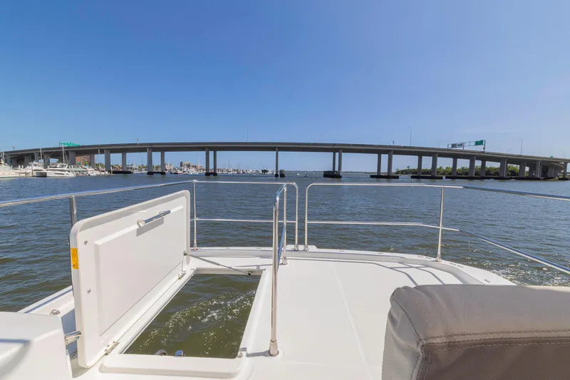 Slide: The Image of 2019 Beneteau Swift Trawler 35 cruising under a bridge on a sunny day. - 39