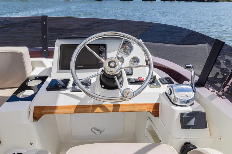 Slide: The Image of Helm of 2019 Beneteau Swift Trawler 35 with steering wheel and controls. - 42