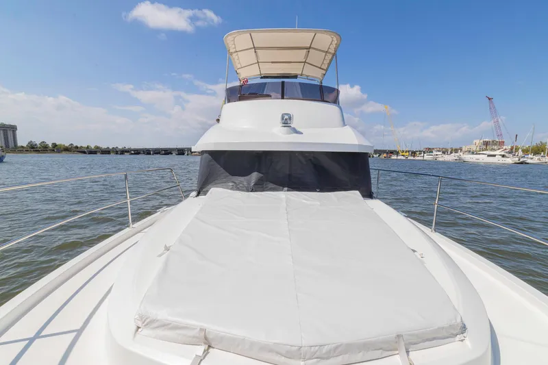 Slide: The Image of 2019 Beneteau Swift Trawler 35 on water, showcasing spacious deck and flybridge. - 44