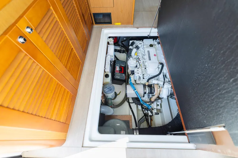 Slide: The Image of Engine compartment of 2019 Beneteau Swift Trawler 35, showcasing mechanical components and storage. - 46