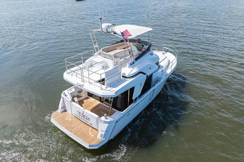 Slide: The Image of 2019 Beneteau Swift Trawler 35 cruising on open water, rear view. - 5
