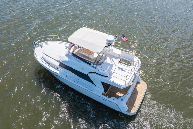 Slide: The Image of 2019 Beneteau Swift Trawler 35 cruising on open water, aerial view. - 51