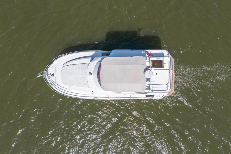 Slide: The Image of Aerial view of 2019 Beneteau Swift Trawler 35 cruising on water. - 52