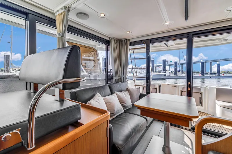 Slide: The Image of Interior of 2019 Beneteau Swift Trawler 35 with modern seating and waterfront view. - 56