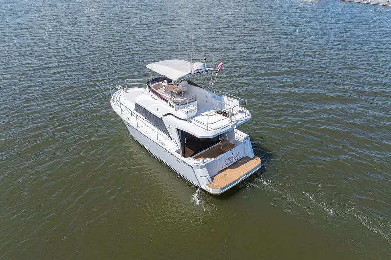 Slide: The Image of 2019 Beneteau Swift Trawler 35 cruising on open water, rear view. - 60