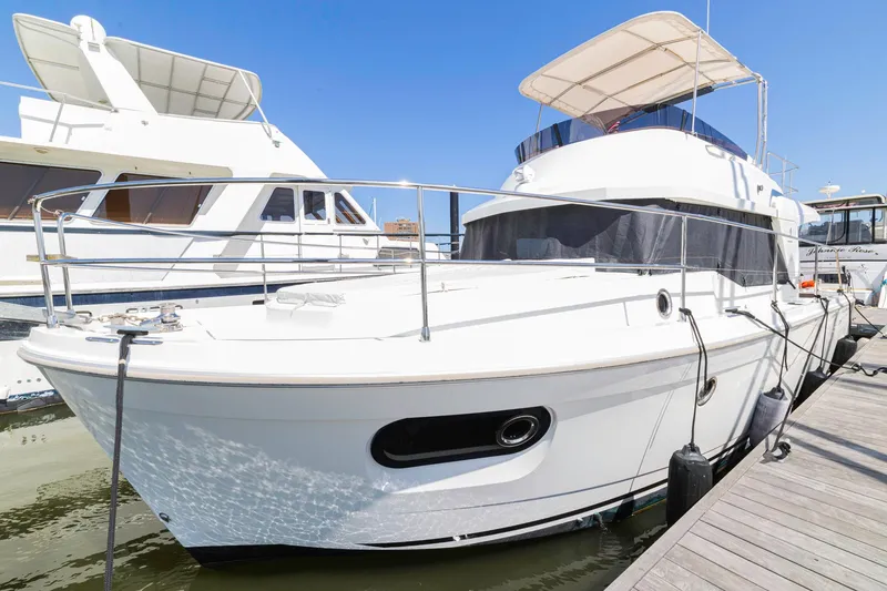Slide: The Image of 2019 Beneteau Swift Trawler 35 docked at marina under clear blue sky. - 61