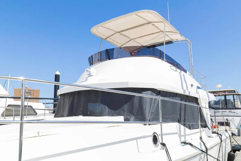 Slide: The Image of 2019 Beneteau Swift Trawler 35 docked under clear blue sky. - 62