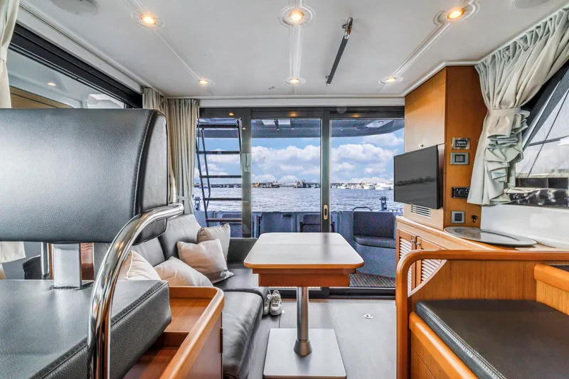 Slide: The Image of Interior of 2019 Beneteau Swift Trawler 35, featuring modern seating and waterfront view. - 9