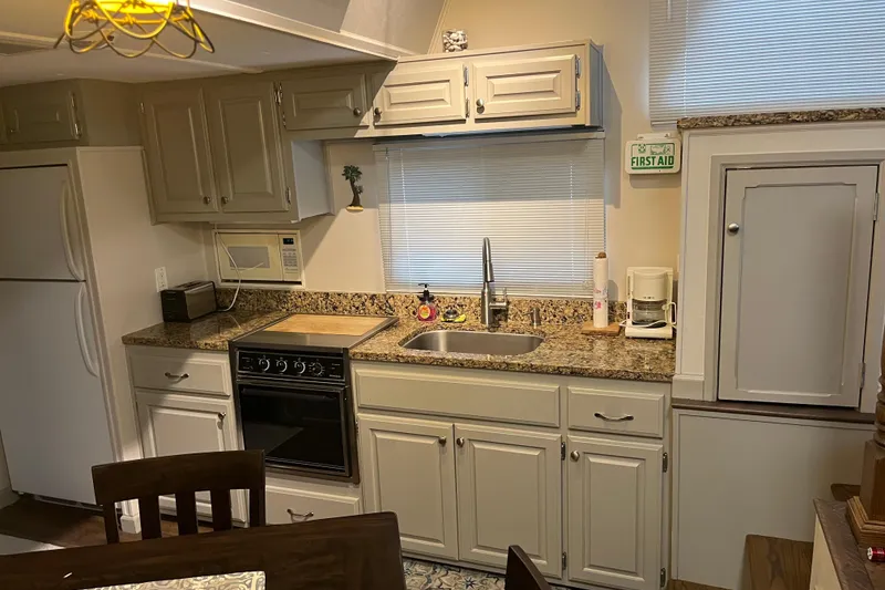 Slide: The Image of Compact kitchen in a 1995 WaveLenth Wide Body RV with granite countertops. - 11