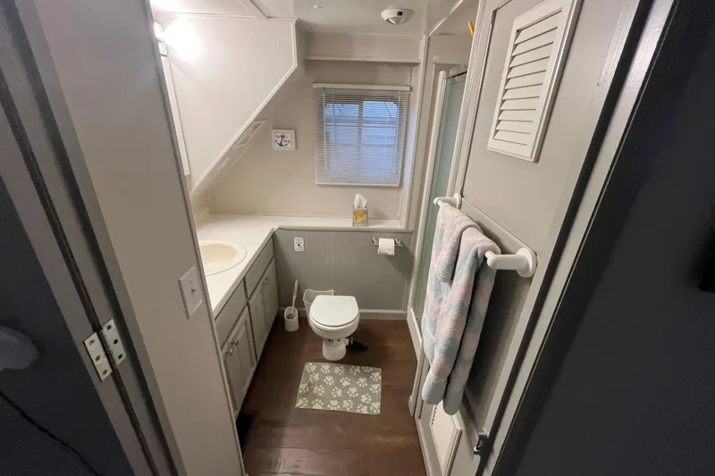 Slide: The Image of Compact bathroom in a 1995 WaveLenth Wide Body RV, featuring a toilet, sink, and shower. - 13