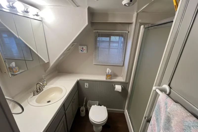 Slide: The Image of Compact 1995 WaveLenth Wide Body bathroom with sink, toilet, shower, and mirror. - 14