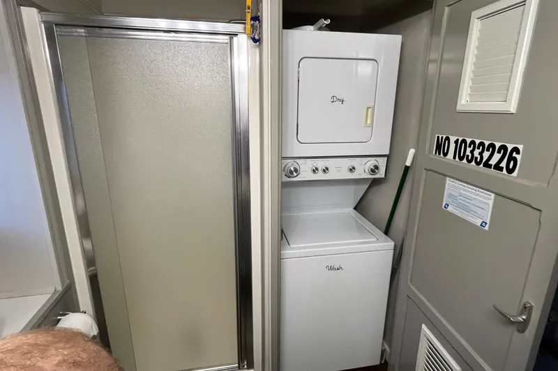 Slide: The Image of Compact laundry area with stacked washer and dryer in a WaveLenth Wide Body 1995 model. - 16