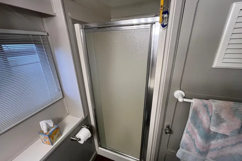 Slide: The Image of Compact 1995 WaveLenth Wide Body RV bathroom with shower, towel, and tissue box. - 17