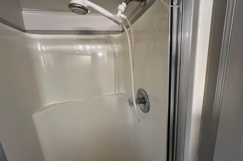 Slide: The Image of Compact shower stall with handheld showerhead in a WaveLenth Wide Body, 1995 model. - 18