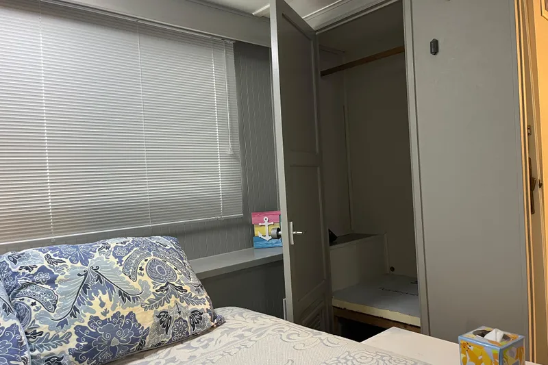 Slide: The Image of Cozy bedroom in 1995 WaveLenth Wide Body, featuring patterned pillows and open closet. - 21