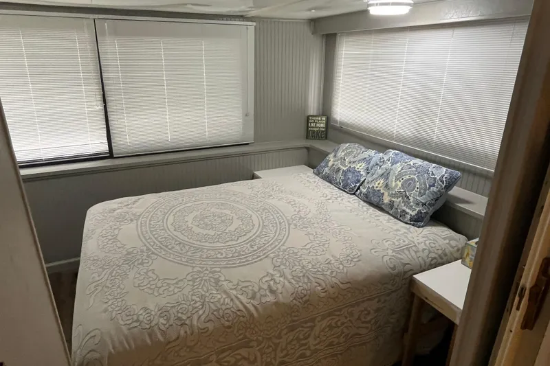 Slide: The Image of Cozy bedroom in 1995 WaveLenth Wide Body with patterned bedding and blinds. - 23