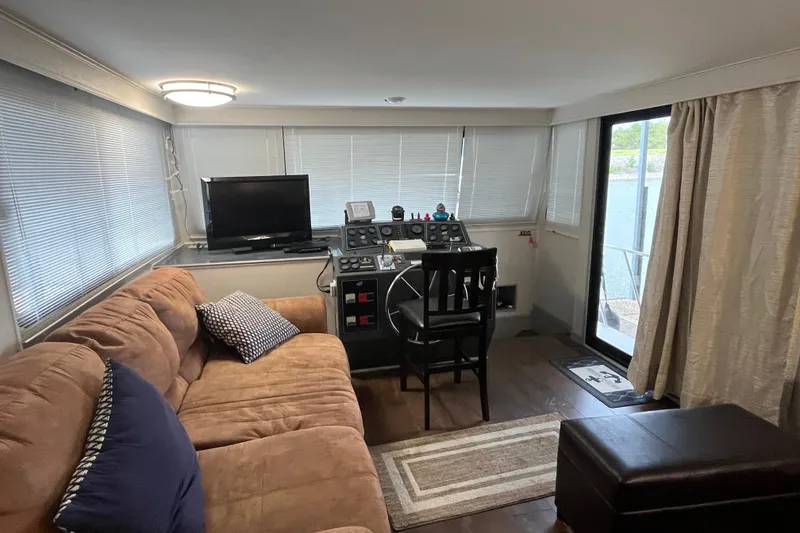 Slide: The Image of Cozy 1995 WaveLenth Wide Body boat interior with sofa, TV, and helm station. - 26