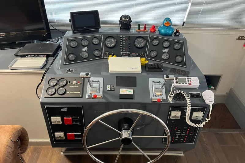 Slide: The Image of Control panel of a 1995 WaveLenth Wide Body boat with gauges and steering wheel. - 27