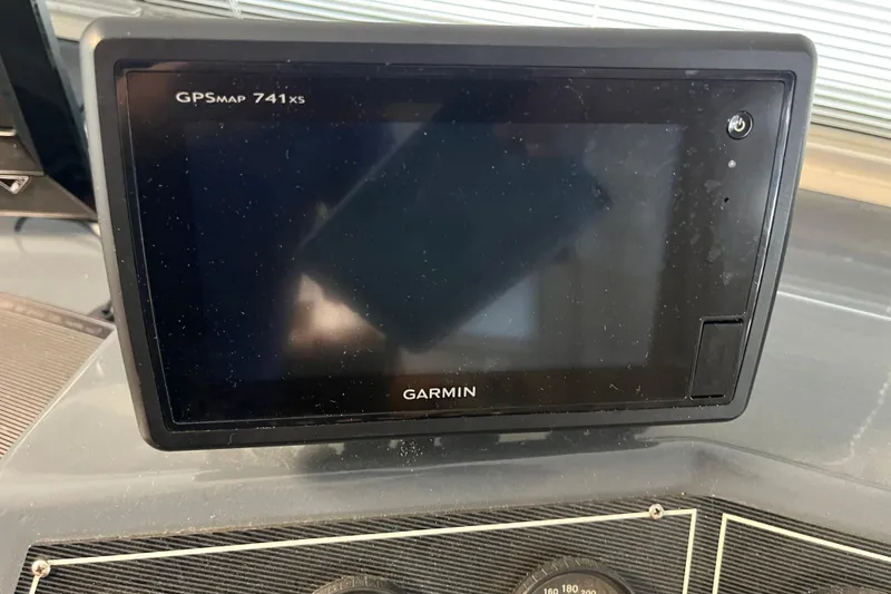 Slide: The Image of Garmin GPSMAP 741xs device on a 1995 WaveLenth Wide Body dashboard. - 28