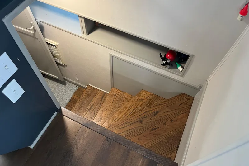 Slide: The Image of Wooden staircase with wall shelf, featuring a 1995 WaveLenth Wide Body model. - 29