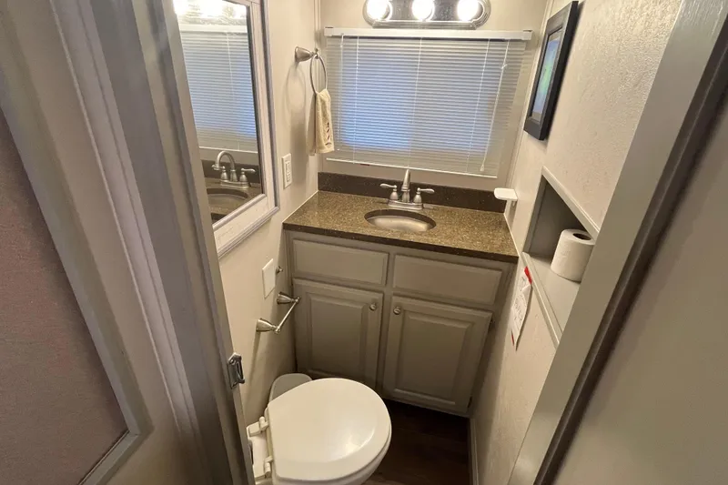 Slide: The Image of Compact bathroom in 1995 WaveLenth Wide Body RV with sink, toilet, and storage. - 31