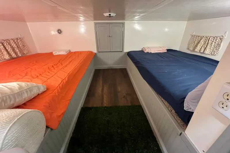 Slide: The Image of Interior of a 1995 WaveLenth Wide Body RV with dual beds and cozy decor. - 32