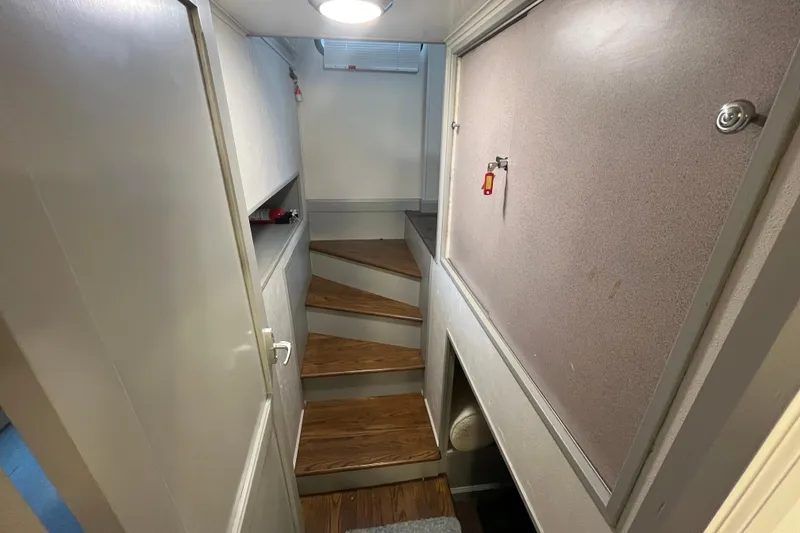 Slide: The Image of Narrow staircase in 1995 WaveLenth Wide Body boat interior with wooden steps. - 33